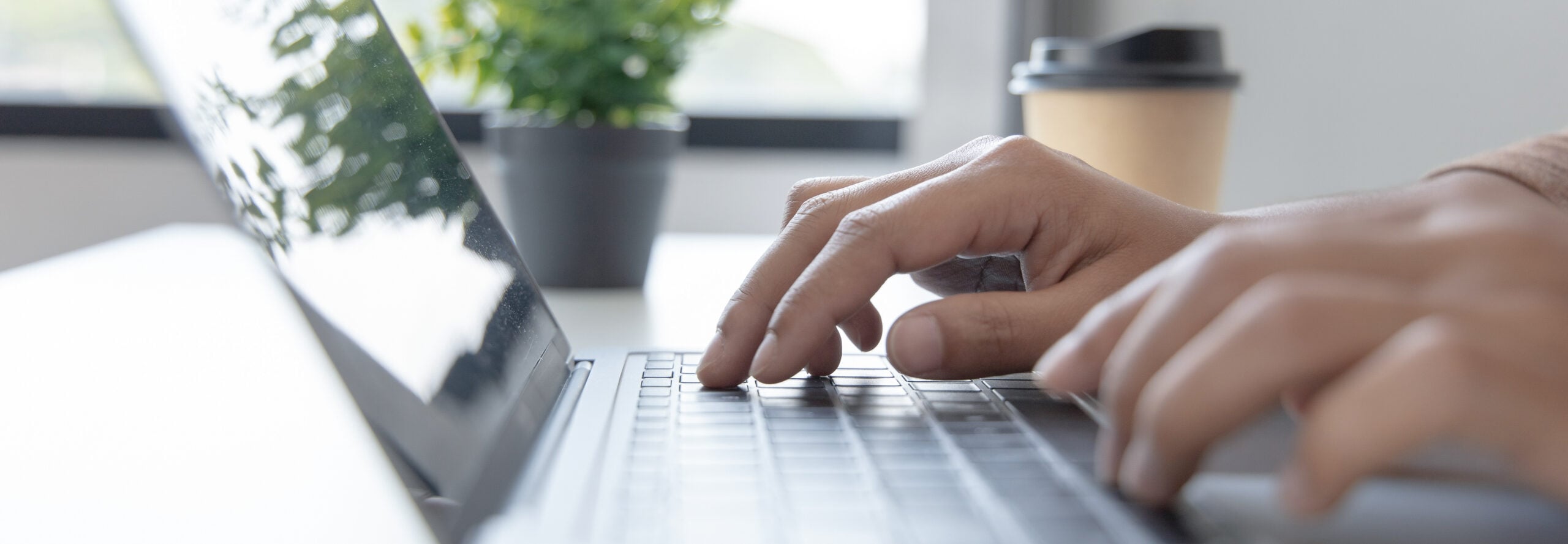 Person typing on a laptop reaching out to UFP Factory Built